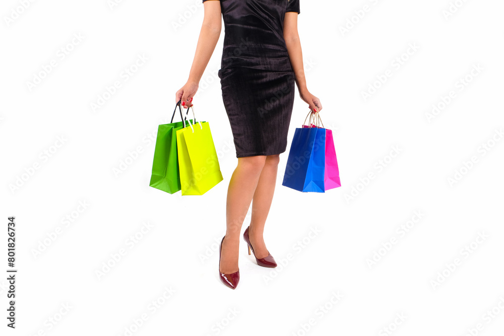 The woman happily and holds colorful shopping bags. She held up the shopping bag. Show happiness in purchasing products