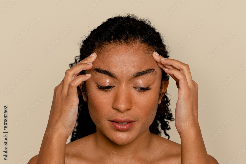 Woman having a headache, and touching her face Woman having a headache, and touching her face