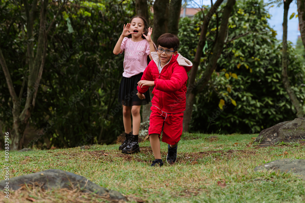 International Children Day. Very happy Latino children playing outdoors, running and smiling. Concept of family and fun. Nature. International Children Day. Very happy Latino children playing outdoors, running and smiling. Concept of family and fun. Nature.