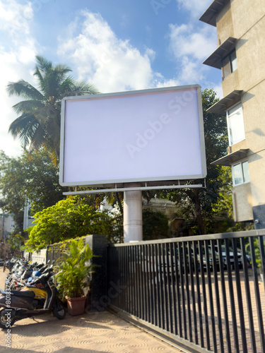 Ooh Billboard mockup outdoors. An empty outdoor at residential places for presentation. hoarding in front of building. Blank commercial mock-up, poster, banner, dummy placement for ads, branding