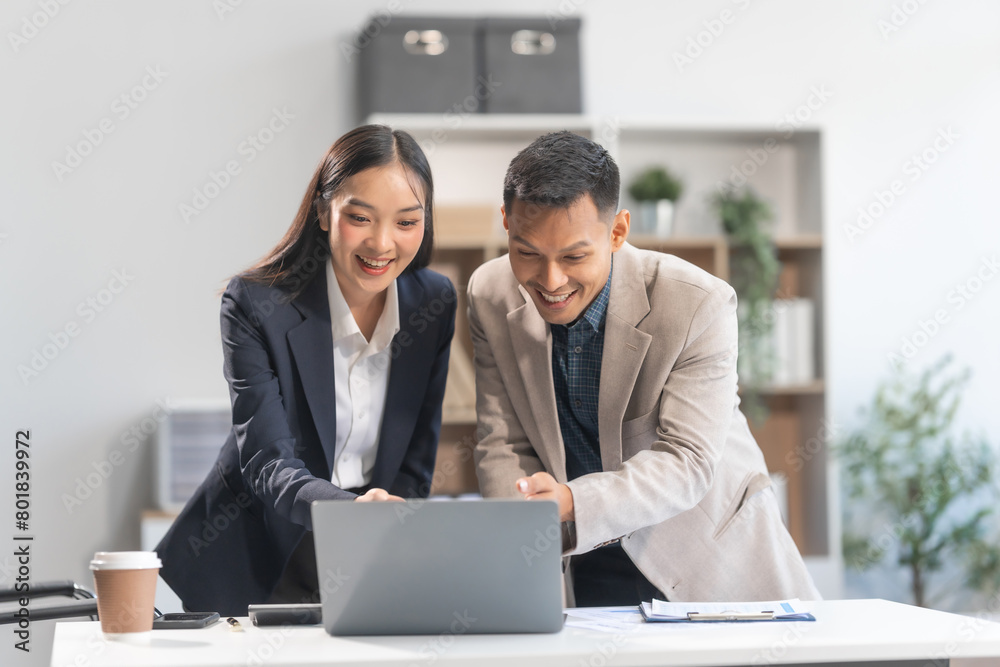 Fototapeta premium Collaboration between young Asian businesswoman and middle-aged businessman, achieving business success through dedication, effective efforts, and triumphant breakthroughs, milestones in careers.