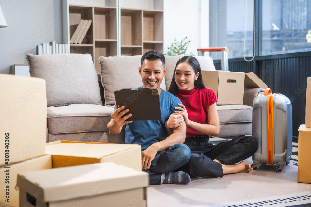 Young Asian couple relocating to a new house, joyfully packing and unpacking belongings. Expertise in moving, packing, togetherness, and creating a new home together. Young Asian couple relocating to a new house, joyfully packing and unpacking belongings. Expertise in moving, packing, togetherness, and creating a new home together.