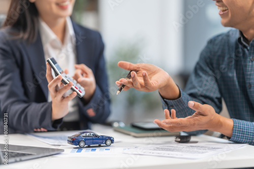 Asian businesswoman specializing in car loan services. Proficient in terms like extended warranty, lease, MSRP, and navigating financing options for customers' automotive needs.