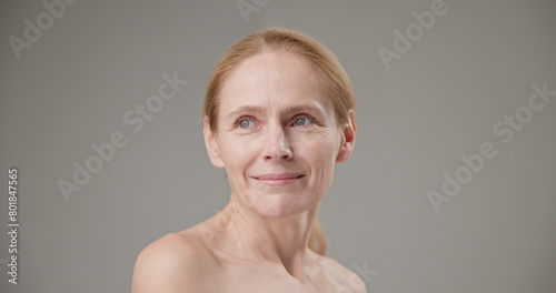 Anti age  Beauty  health and dry skin care real people concept - beautiful middle-aged mature Caucasian woman in her 50s looking at the camera with a slight smile
