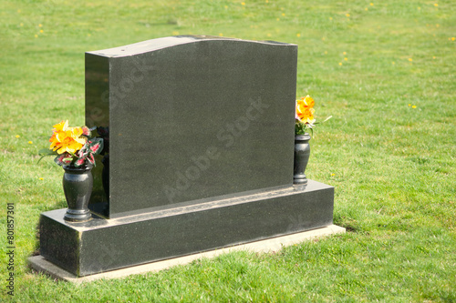 Large tombstone with flowers and space for a message.