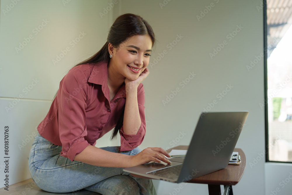 Happy Asian businesswoman on balcony using laptop to do morning work Business woman on holiday working outside that is natural Beautiful blogger woman thinking about content for work. Happy Asian businesswoman on balcony using laptop to do morning work Business woman on holiday working outside that is natural Beautiful blogger woman thinking about content for work.