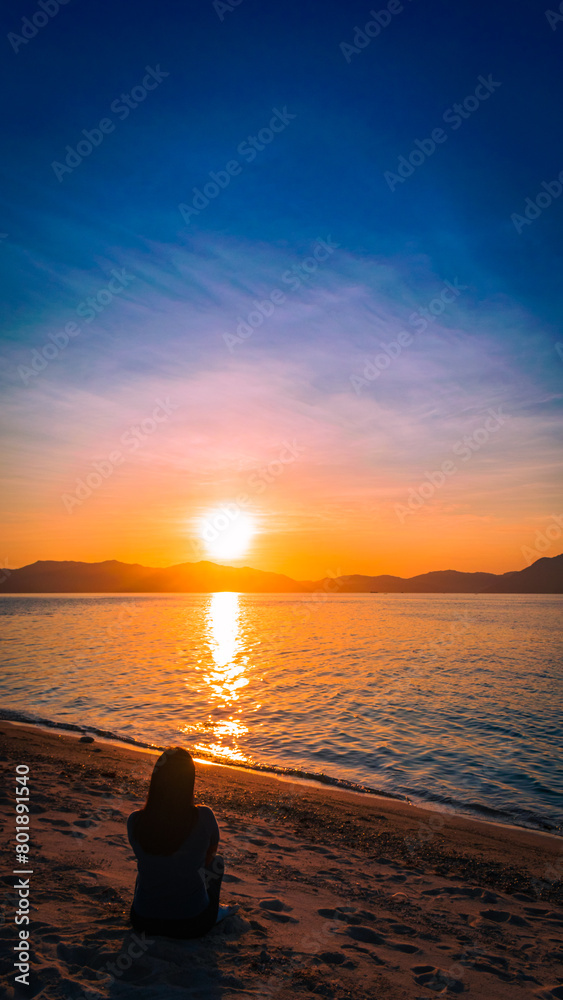 Golden sunset at sea. Portrait. Bonbon Beach, Romblon Island, Philippines