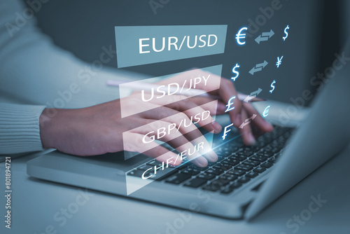 Currency exchange global financial banking interbank foreign exchange and payment concept, with a businessman holding currency and using a computer laptop with finger pointing at symbols.