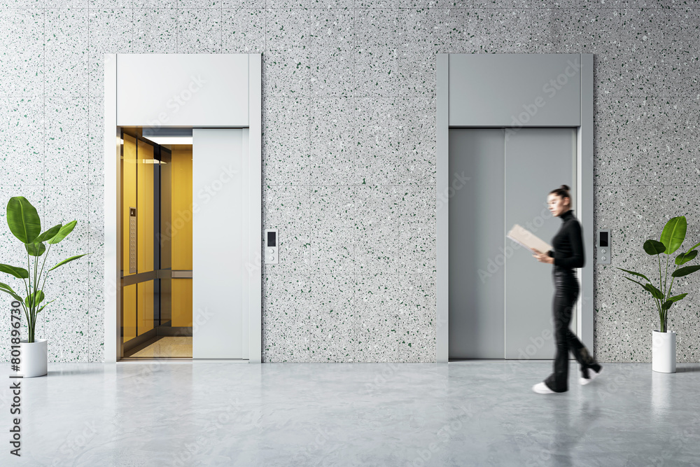 Fototapeta premium Woman brisk walking past modern elevator in office lobby, corporate hustle concept
