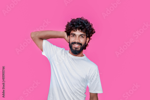 Handsome joyful smiling young indian man looking aside up and straight thinking of new good opportunities, dreaming, feeling inspired and proud standing isolated on pink background. Portrait