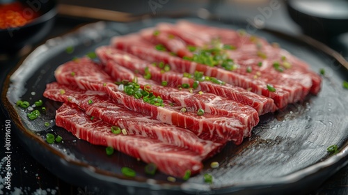 In the center of the frame is a table, on which there is A plate of sliced beef, delicately plated, with a clear texture of the beef, red and white, looks appetizing, The picture has depth of field