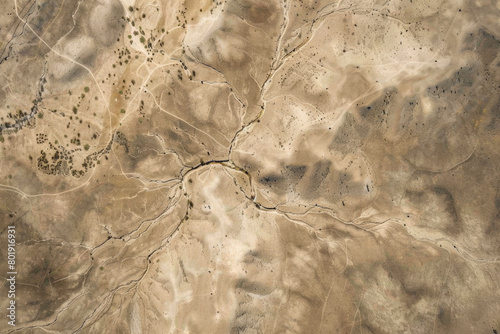 An aerial view of a dried-up riverbed after being washed away by the river, with a vast expanse of land.