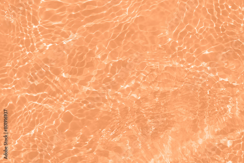 Orange water with ripples on the surface. Defocus blurred transparent orange colored clear calm water surface texture with splashes and bubbles. Water waves with shining pattern texture background. © Water 💧 Shining 📸