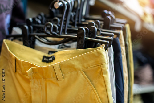 Colorful clothes are hung on a clothesline in a clothing store.