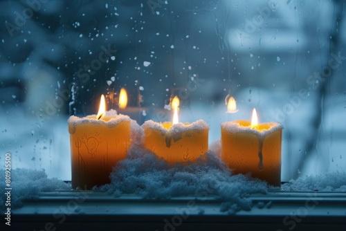 A burning candle on a windowsill during winter  with additional heating devices needed due to extreme temperatures.  
