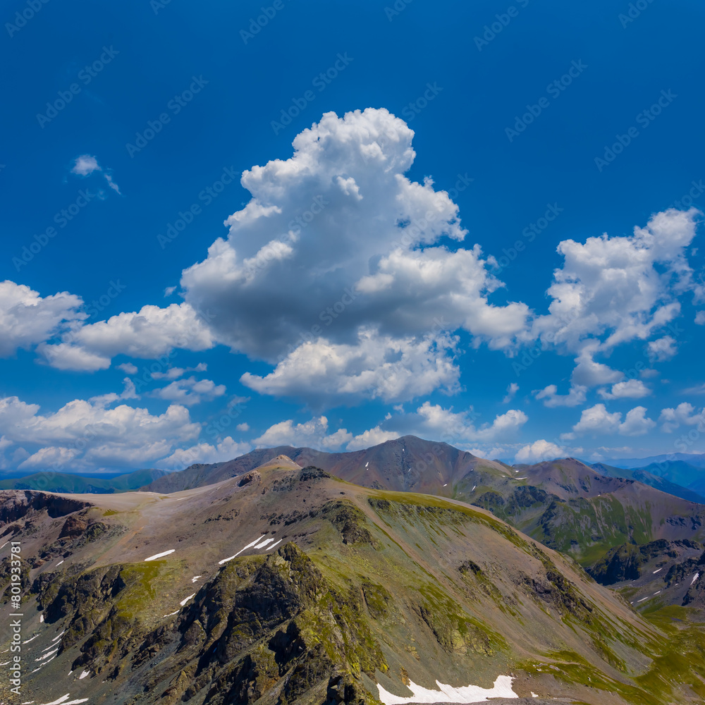 green mountain valley under a blue cloudy sky