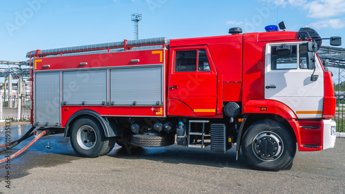 A red fire truck for delivering firefighters to the fire site and supplying extinguishing agent for extinguishing. Equipment for extinguishing and rescuing people in case of fire. Fire department
