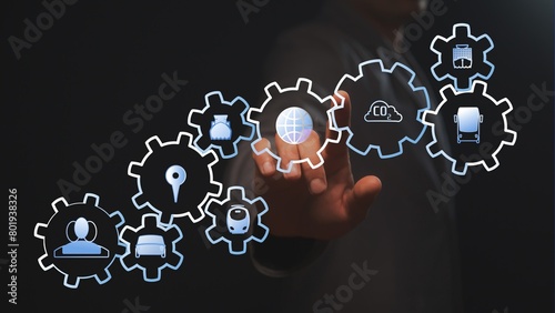 The businessman points to a chain of gears in which the types of vehicles involved in environmental pollution are located. Decarbonization concept. Dark background. Cg