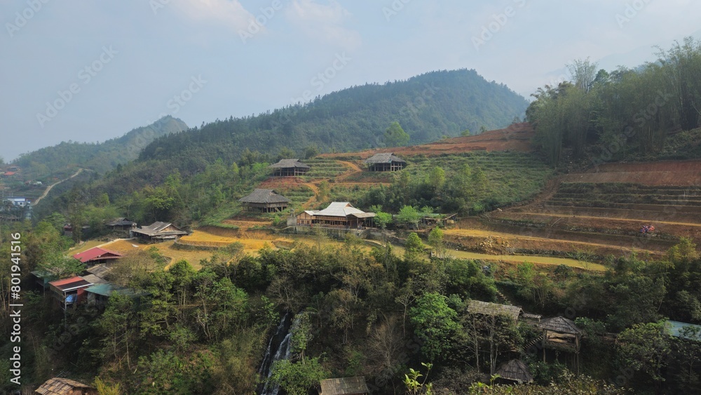 Obraz premium Hills, mountain, terraced fields and traditional houses in Sapa town, lao Cai province, Vietnam in the afternoon with fog.