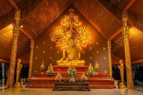 The gold Buddha in the Wat Sirindhorn Wararam or Wat Phu Prao, also known as the Glow Temple, is located in Sirindhorn, Ubon Ratchathani, Thailand photo