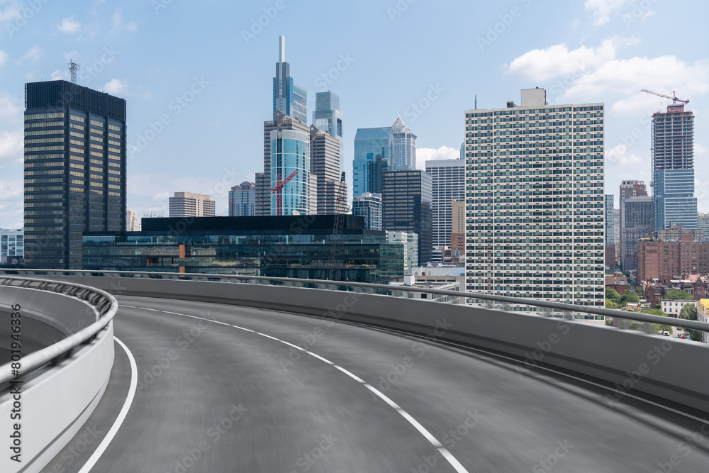 Empty urban asphalt road exterior with city buildings background. New modern highway concrete construction. Concept way to success. Transportation logistic industry fast delivery. Philadelphia. USA.