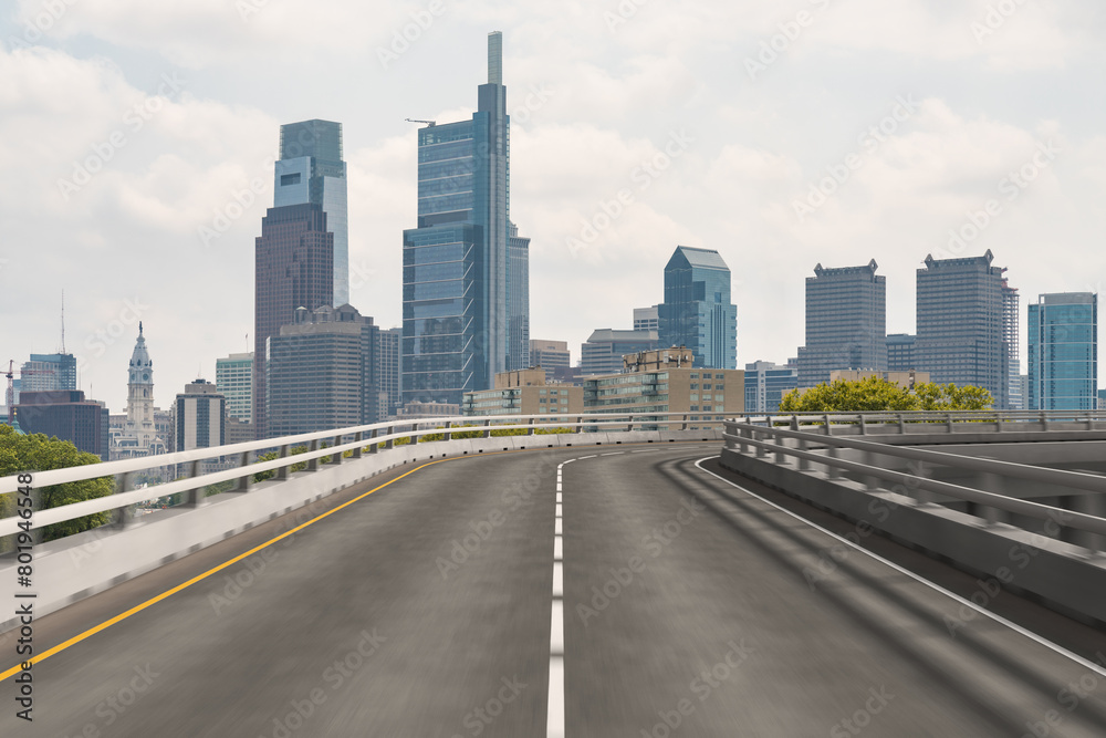 Empty urban asphalt road exterior with city buildings background. New modern highway concrete construction. Concept way to success. Transportation logistic industry fast delivery. Philadelphia. USA.