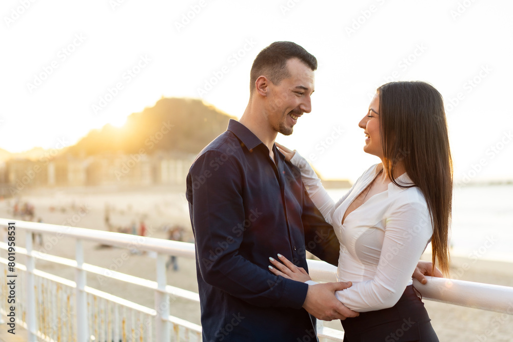 Young elegant couple embracing looking each other during sunset Young elegant couple embracing looking each other during sunset