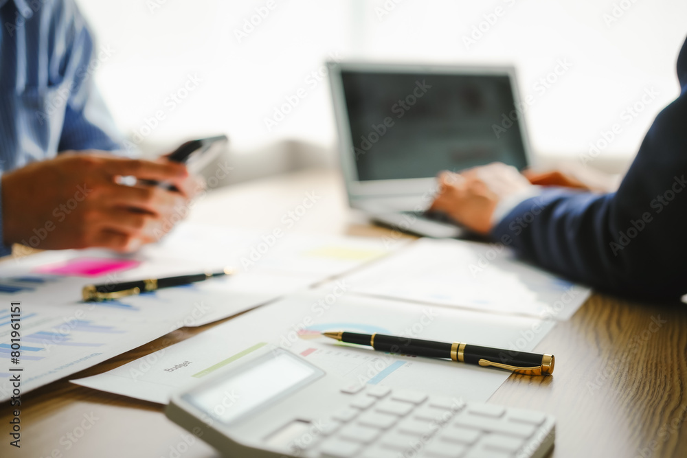Desk-bound businessman calculates figures, verified accounts, and collaborates in discussions. Proficient in using calculators, aiding each other, and managing annual tax accounts in the audit office Desk-bound businessman calculates figures, verified accounts, and collaborates in discussions. Proficient in using calculators, aiding each other, and managing annual tax accounts in the audit office
