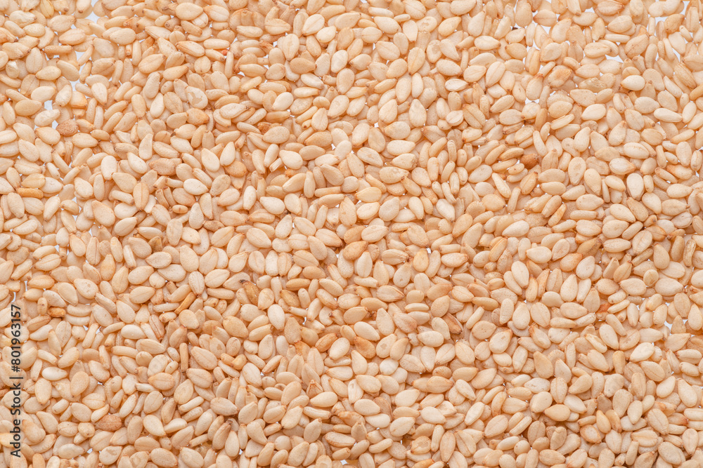 White sesame seeds closeup. Food background. White sesame seeds closeup. Food background.