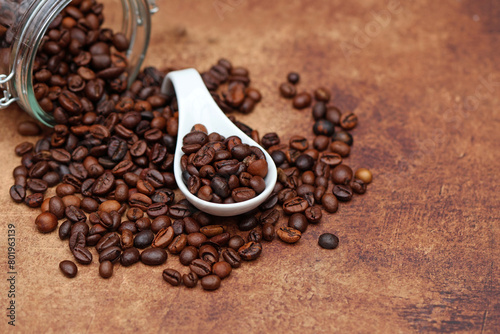 Roasted coffee beans on a brown background.
