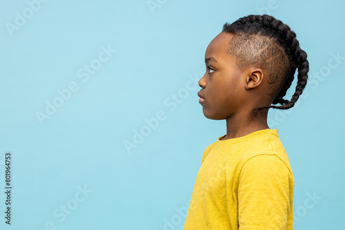 Waist up of a cute african american boy in yellow tshirt