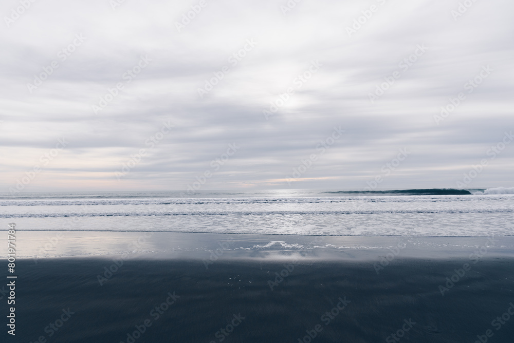 Cloudy afternoon on a black sand beach Cloudy afternoon on a black sand beach