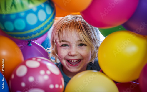 Picture a sweet kid happily playing with bright balloons. 
