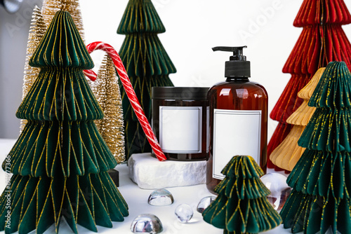 dark jar with lid and dispenser on the background of Christmas decorations, side view