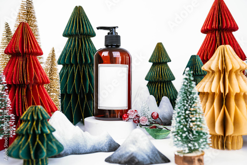 dark jar with dispenser on the background of Christmas decorations, side view
