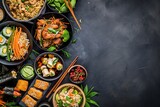 Asian cuisine with meat on a dark background in a restaurant, top view, copy space
