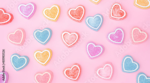 Colorfully heart jelly on a pink background.