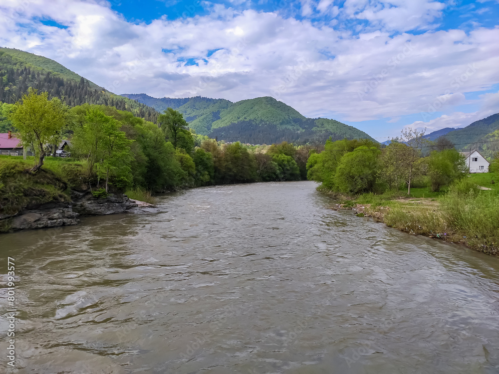 Crossing the bridge over the river in the Ukrainian Carpathians