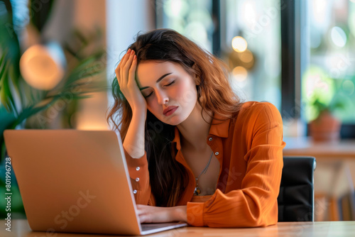 Worried fatigued young business woman having headache at work. Tired upset busy 30s middle aged businesswoman feeling stress having problem at workplace looking at laptop computer in office.