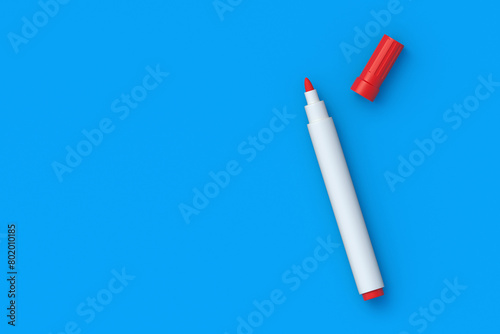 Red felt pen on blue background. School and office supplies. Top view. Copy space. 3d render