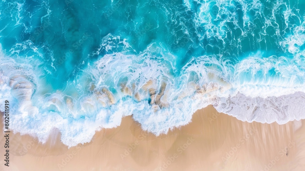 The ocean is calm and blue, with white foam on the waves