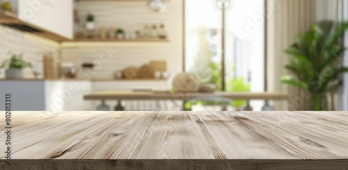 a wooden table top with a blurry kitchen in the background