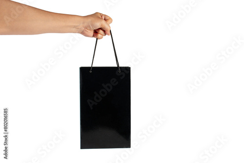 Hand Holding black paper bag isolated on transparent background.