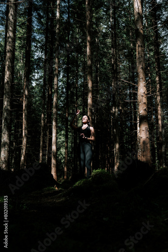 Young woman stands on Sadhu boards in the forest. Sadhu boards. Meditation and nailing concept