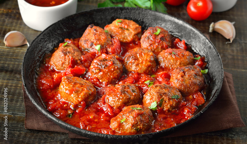 Meatballs with parsley in frying pan