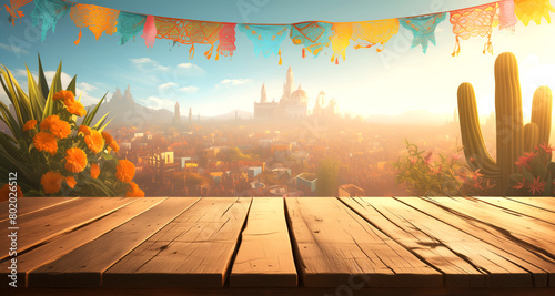 Cinco de Mayo with an empty wooden table top featuring Mexican flags, cactus plants, and colorful serapes photo