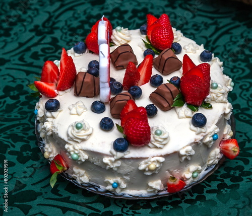 A festive cake in close-up on a dark tablecloth background