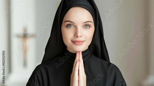 Serene caucasian nun in black habit praying devoutly inside the tranquil and peaceful church photo