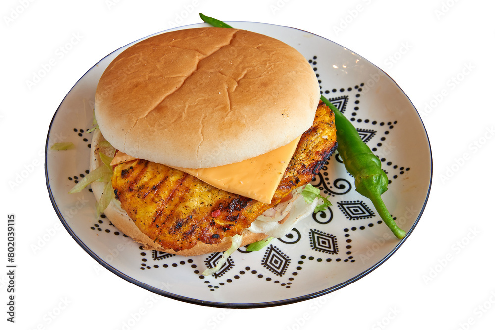 Chicken burger on decorated plate on wooden textured table