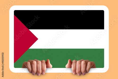 Hands holding a white frame with Palestine flag, independence day idea, two hands and frame